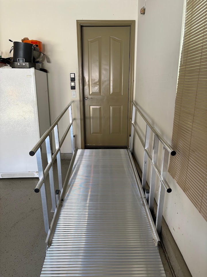 Modular aluminum ramp with railings installed at a home