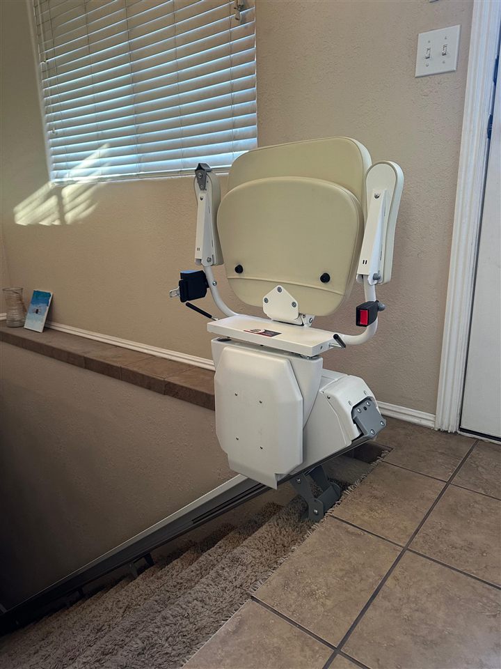 Straight stairlift installed at the bottom of a staircase