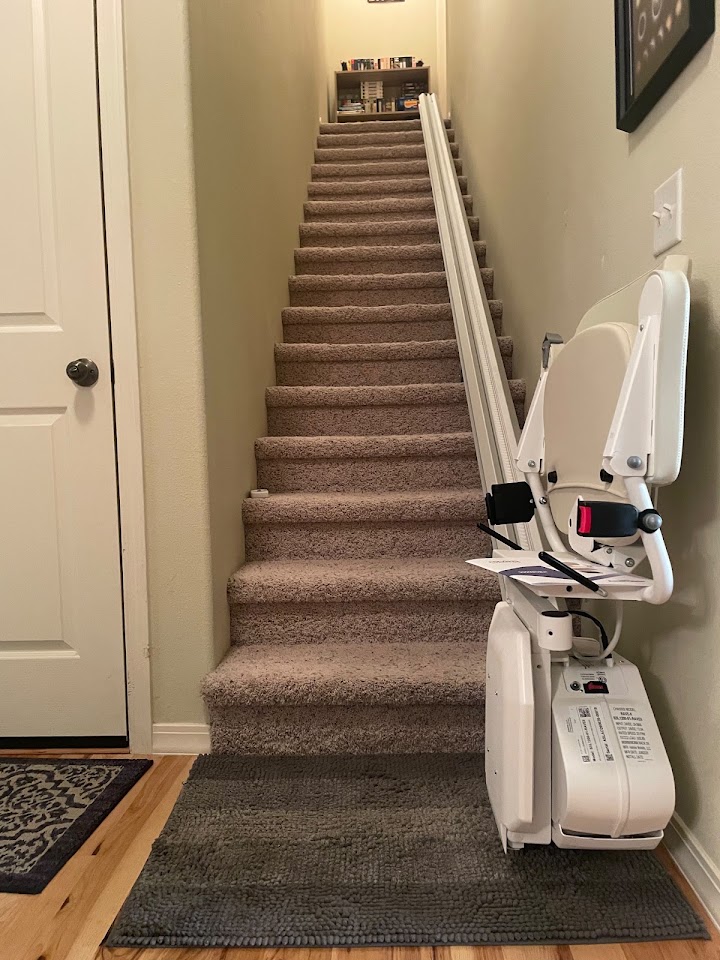 Straight stairlift installed on a carpeted staircase