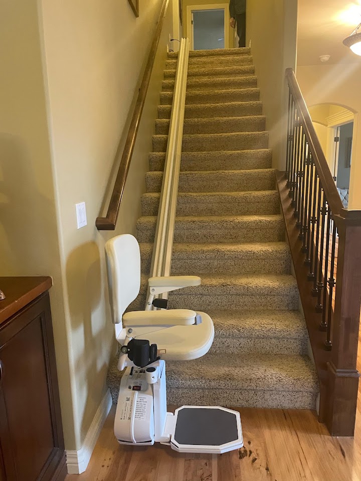 Straight stairlift installed on a carpeted staircase